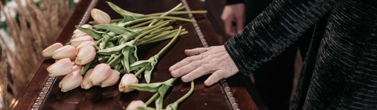 Person holding coffin
